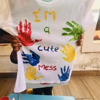 Child showing a painted shirt at Twinkle Toes