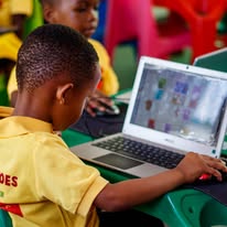 Children learning together on a computer at Twinkle Toes