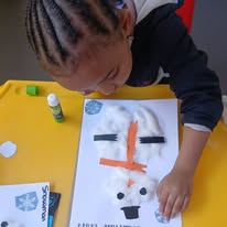 Child making a paper craft at Twinkle Toes