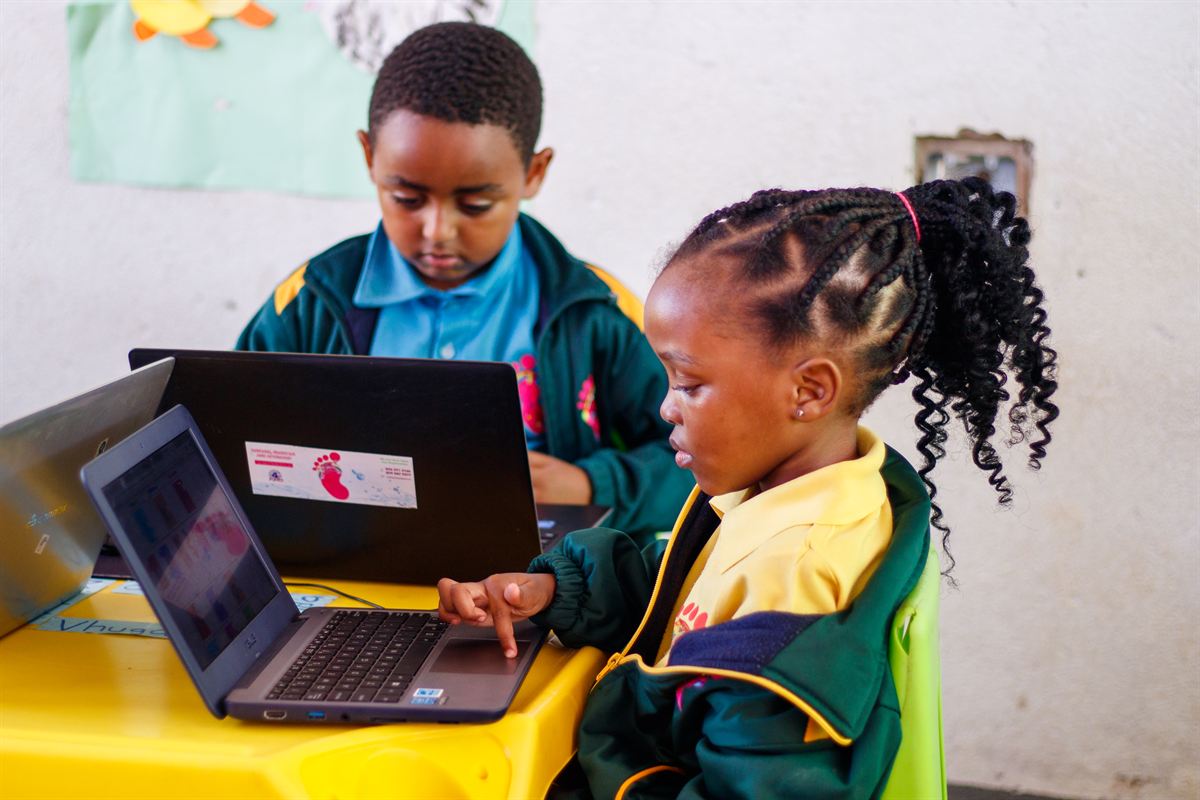 Two Vantage Point learners using laptops in a computer lesson